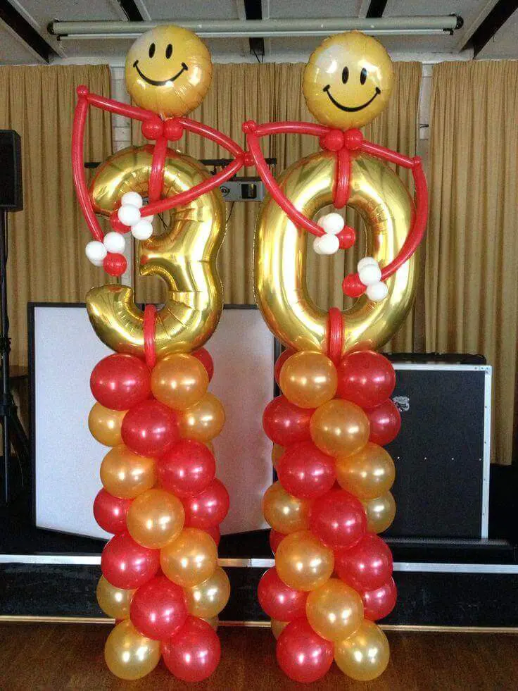 Red and gold latex balloons with mini gold 30th balloons arranged in a column.