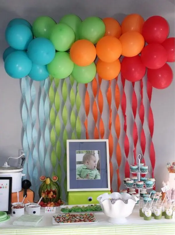 A beautiful arch made of Azure, Green, Orange, and Red latex balloons, perfect for adding a festive touch to an anniversary party in Soho, delivered by Balloons Lane Balloon Delivery.
