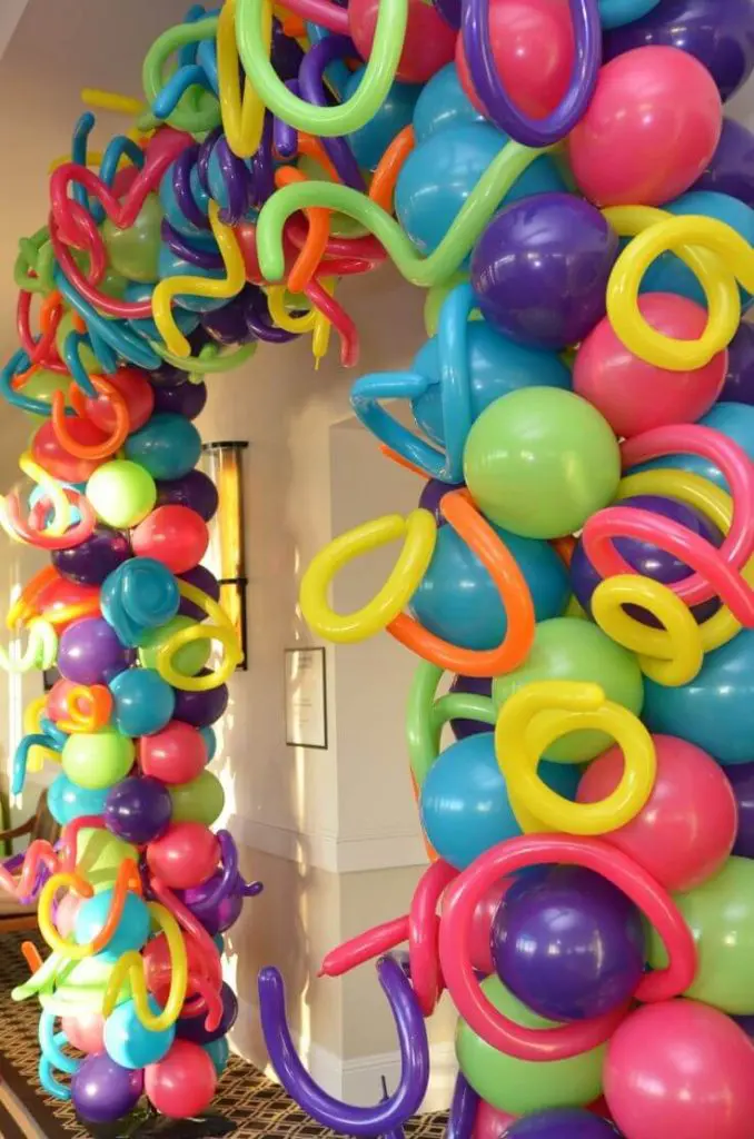 A colorful arch made of Blue, Pink, Purple, Green, Yellow, Orange, and Red latex balloons, perfect for adding a vibrant touch to any decoration in NJ, delivered by Balloons Lane Balloon Delivery.