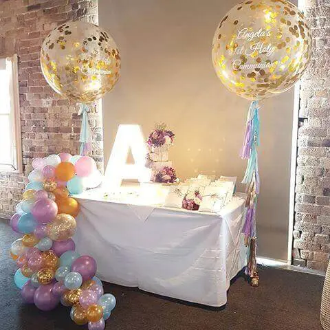 orange sky blue gold and purple round clear balloons​ big clear communion confetti balloons with tassels and organic balloons garland around the table