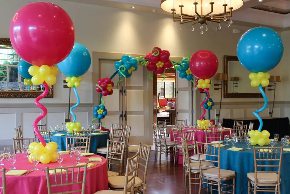 A beautiful arch made of Blue, Yellow, Sparkling Burgundy, and Robin's Egg Blue balloons, perfect for adding a stylish and eye-catching touch to an event in Manhattan, delivered by Balloons Lane Balloon Delivery.