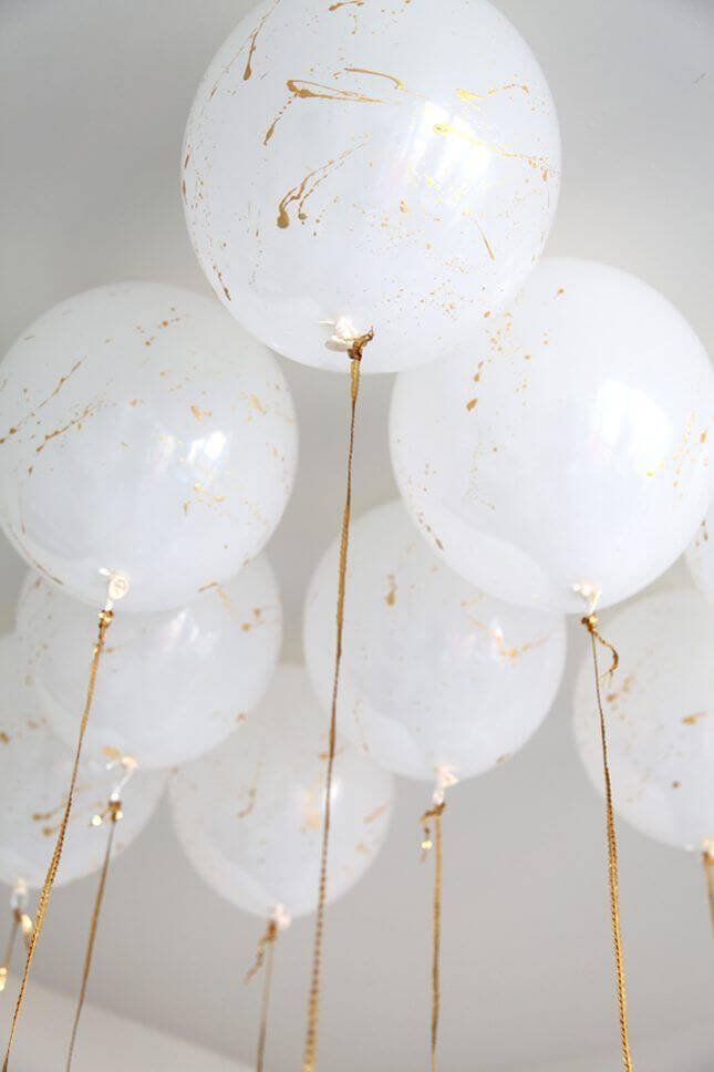 big white golden marble balloons on long golden strings for sweet 16 birthday or quinceanera party
