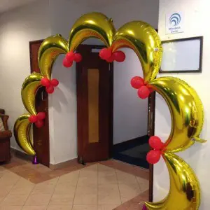 A beautiful arch made of Gold and Red balloons, featuring a Golden Moon, perfect for adding a touch of elegance and romance to an anniversary event in NYC, delivered by Balloons Lane Balloon Delivery.