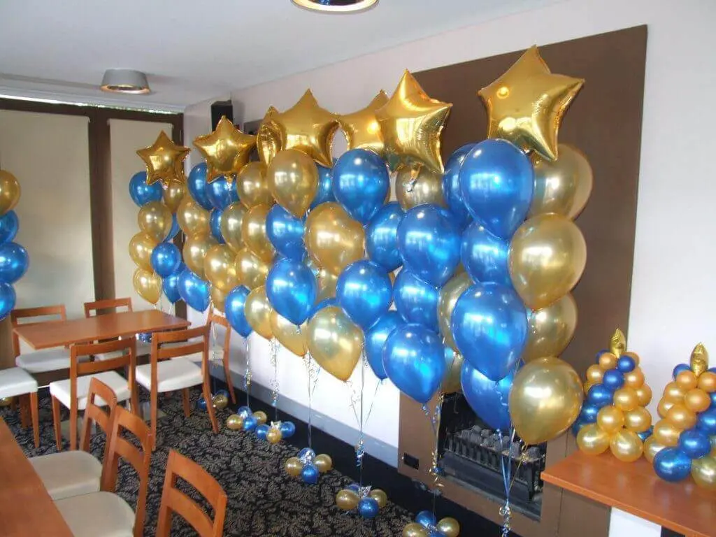 Blue and gold balloon column with golden star balloons for an occasion in Soho by Balloons Lane Balloon Delivery