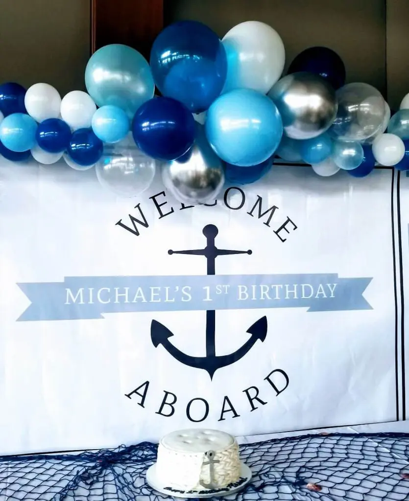 A beautiful arch made of Dark Blue, Silver, White, and Robin's Egg Blue balloons, perfect for adding a touch of elegance and sophistication to an anniversary event in Soho, delivered by Balloons Lane Balloon Delivery.