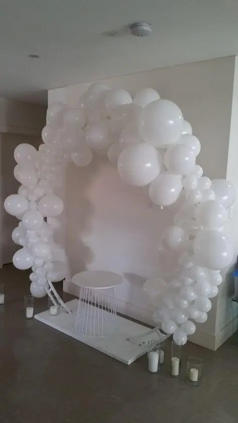A stunning arch made of White round organic balloons, perfect for adding a touch of elegance and simplicity to any occasion in New York City, delivered by Balloons Lane Balloon Delivery.