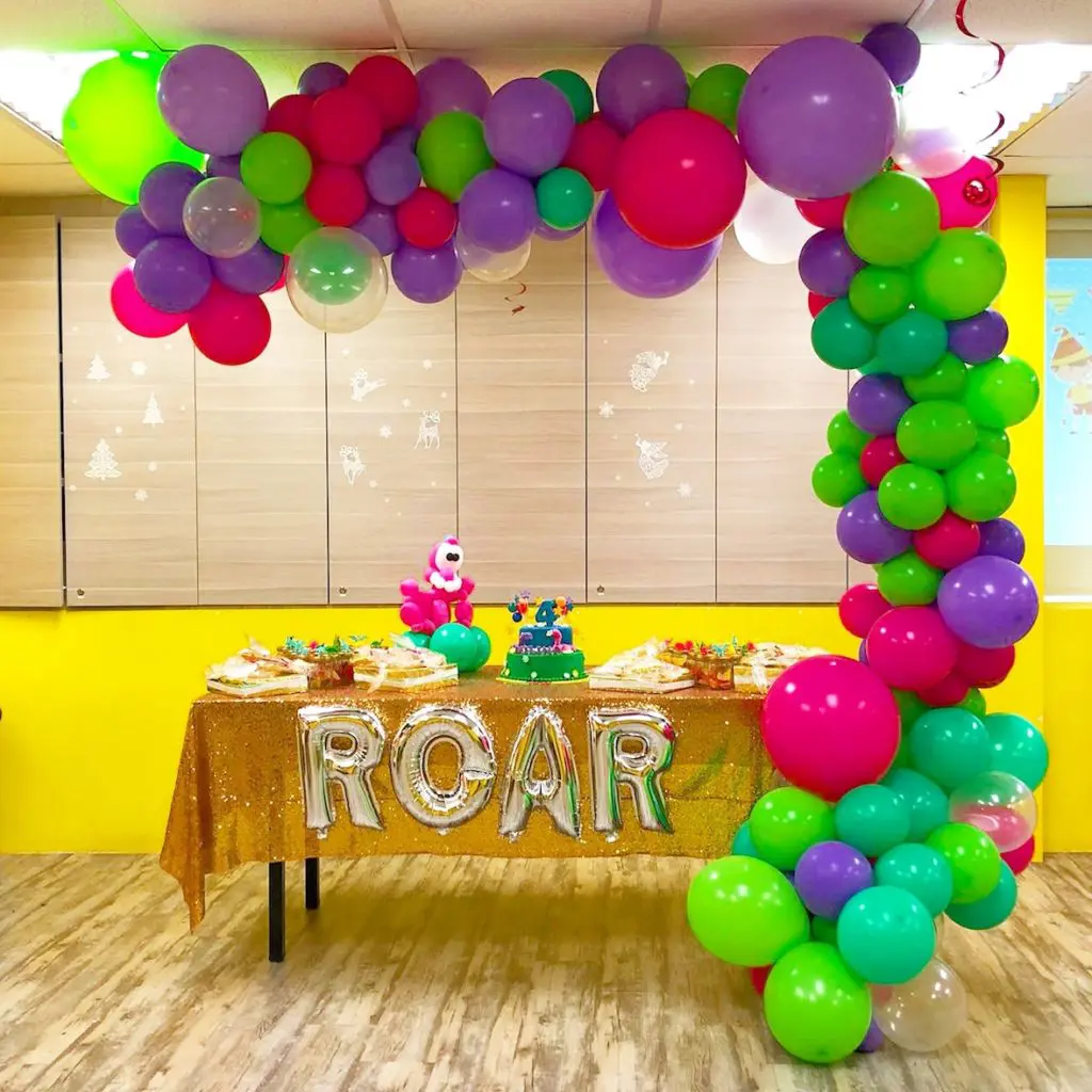 A garland half arch using jewel lime, purple, white, spring lilac, magenta, wintergreen, and neon-colored balloons would make for a vibrant and festive decoration for any occasion in Manhattan!