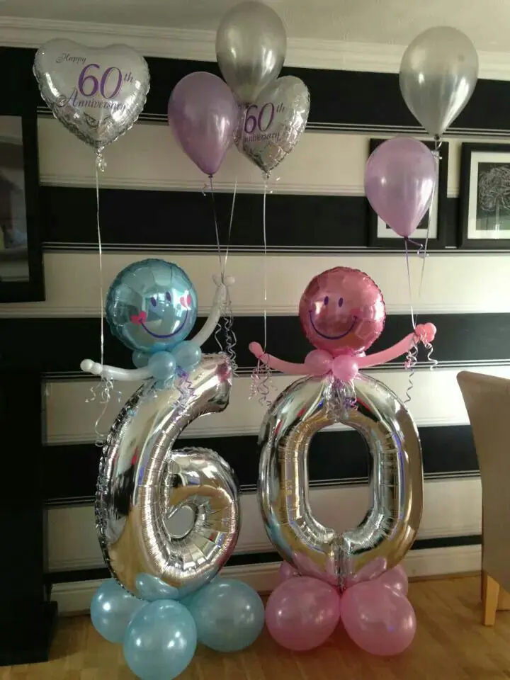 big silver 60 number balloons with smiley face balloons in pink and blue latex