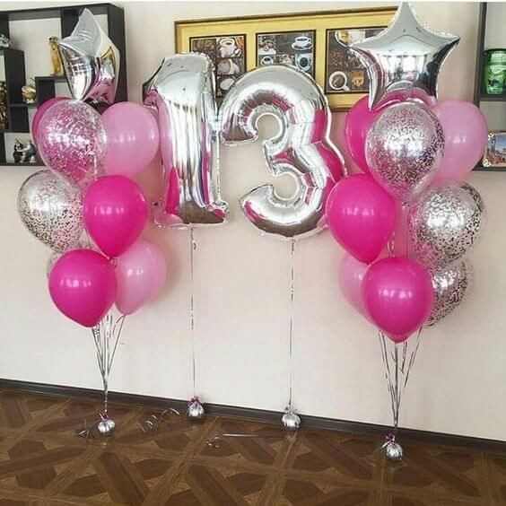 big number 13 in silver with silver confetti birthday or anniversary balloons