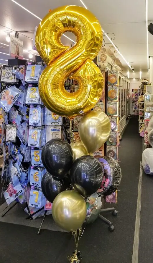 big number 8 balloons centerpiece with chrome gold and black latex balloons for birthday or anniversary