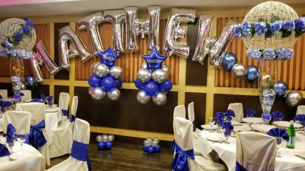 A festive arch made of Chrome Silver and Blue Balloons arranged into big letters spelling "Bar Mitzvah", perfect for adding a celebratory touch to a birthday party.