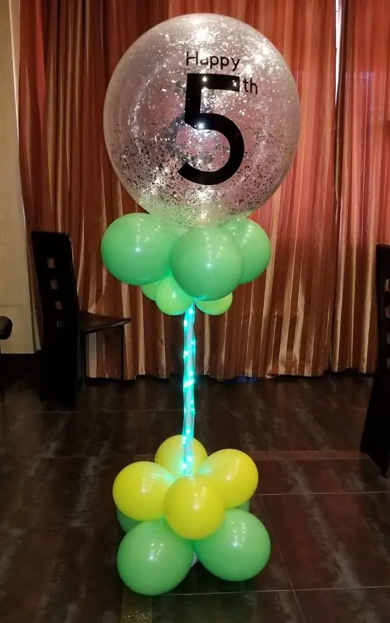 Column of green, yellow, and white balloons with 5th birthday silver confetti balloons delivered by Balloons Lane in Staten Island