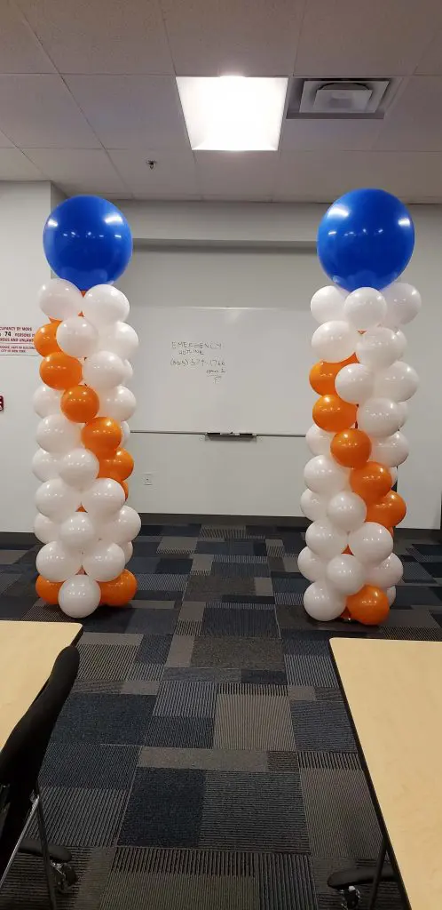 White, orange, and blue confetti balloon column by Balloons Lane in Brooklyn