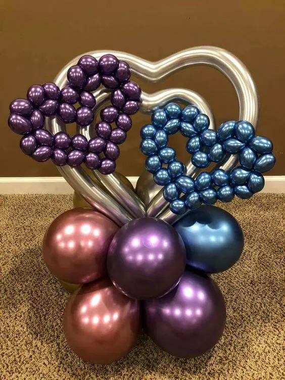 A collection of balloons in pearl midnight blue, chrome rose gold, chrome purple, and heart-shaped designs for Valentine's Day decorating.