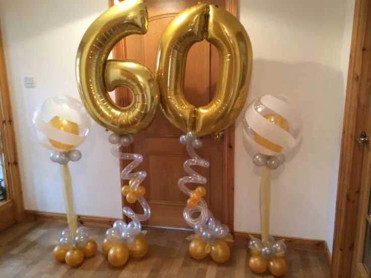 White latex balloons with gold 60th birthday balloons for a special occasion