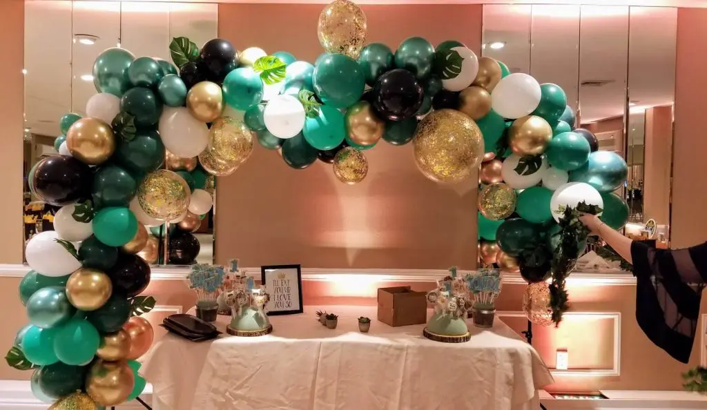 Balloons Lane in Soho Presents gold and green Black White balloons garland arch