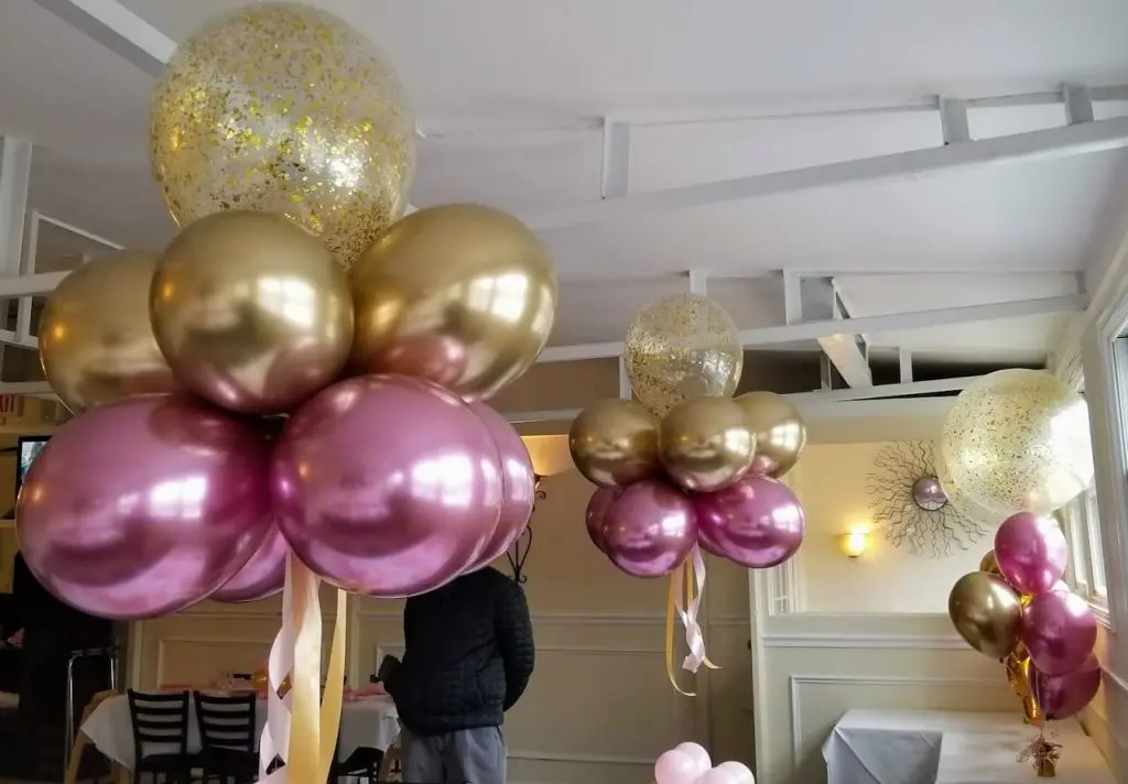 Pink and gold latex christening balloons with gold air balloon centerpieces