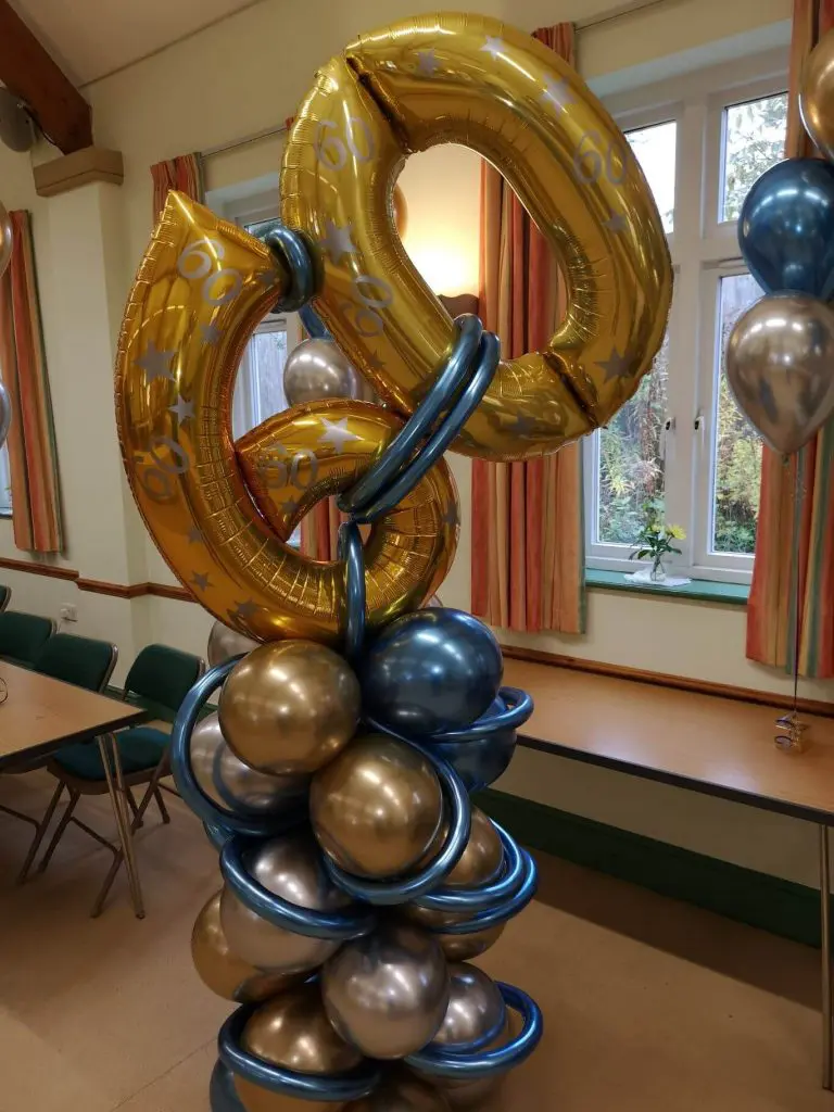 Chrome Blue, Chrome Gold, Chrome Silver, and Gold latex balloons with "Happy 60th Birthday" for a milestone celebratin