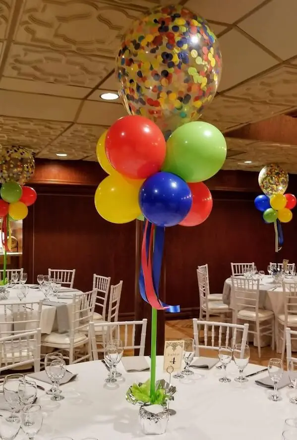 Clear balloon with colorful polka dot with string and orange, green, pink, and light blue balloons centerpiece