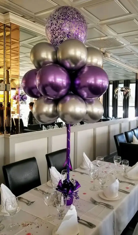 Silver and lavender balloon centerpieces with clear purple confetti accents