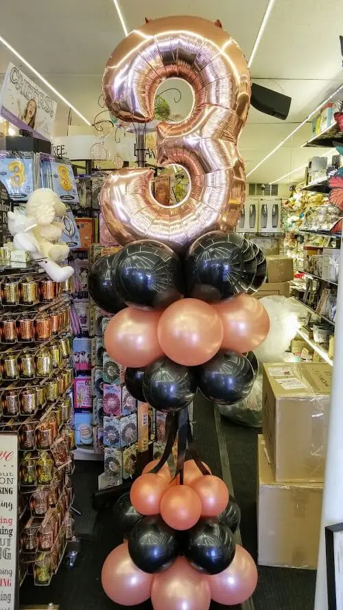 rose gold and black balloons with rose gold number 3 balloons for birthday party