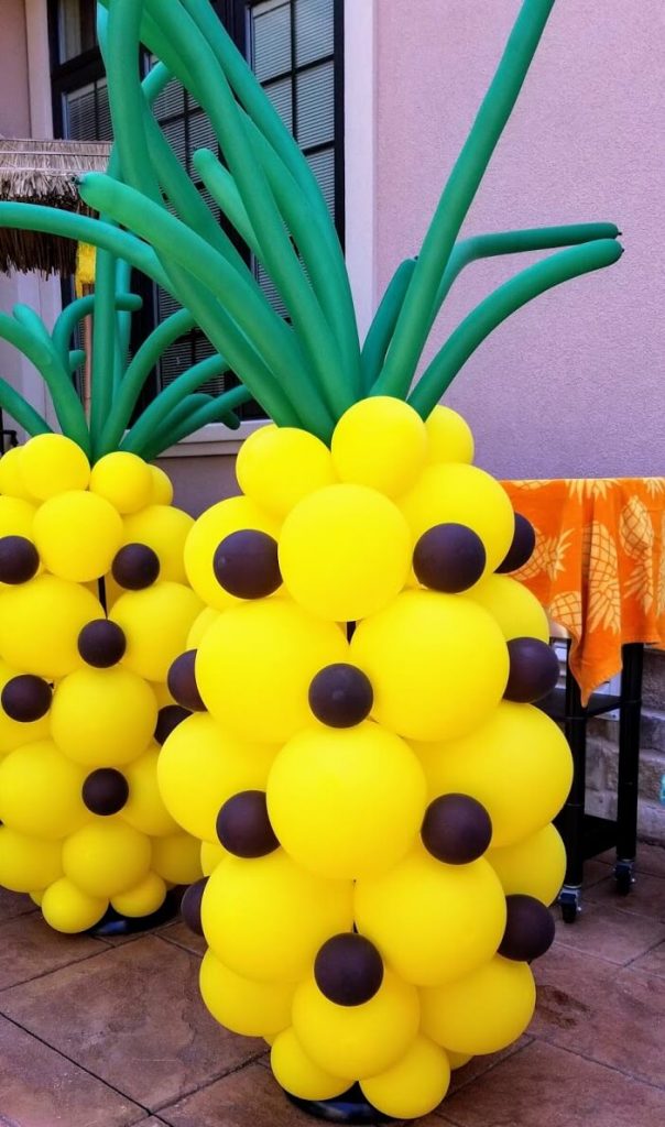 pineapple balloons centerpiece for Hawaii birthday party theme