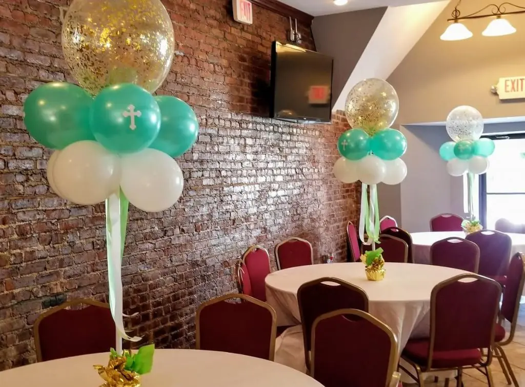 Balloon delivery service offers mint green and white latex balloons for communion celebration, along with a bouquet of clear balloons filled with gold confetti.
