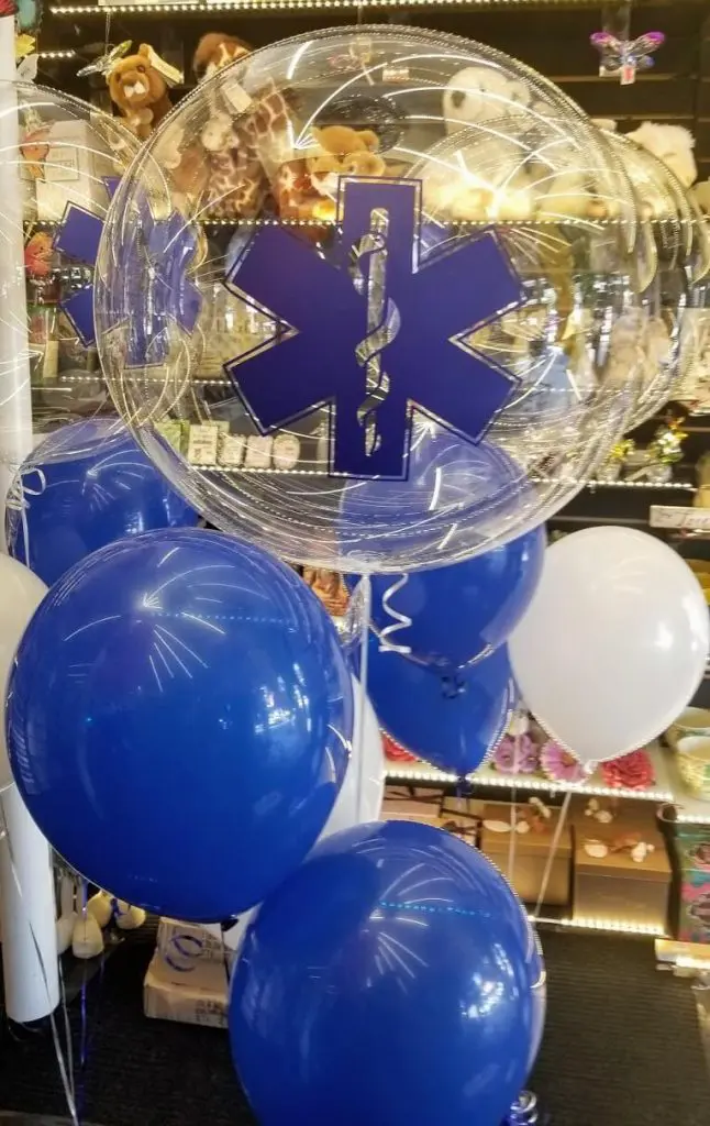 The centerpiece features blue and white balloons arranged in a column and tied to a weight at the base. The balloons add a celebratory touch to the event, and could also be used as centerpieces for a bar mitzvah or other party.