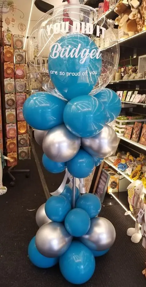 Graduation balloons in teal and silver colors arranged in a balloon column with a "Congrats" balloon, delivered by Balloon Lane in Staten Island.