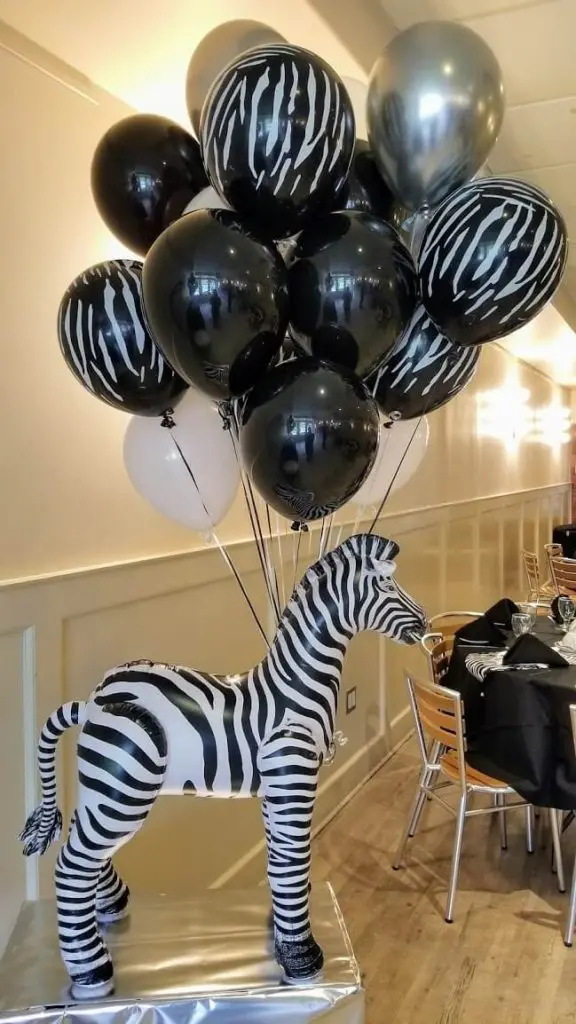 Balloons Lane in Brooklyn creates stylish centerpieces using a mix of black, white, and silver balloons, as well as zebra stripe print balloons. These decorations are perfect for adding a touch of sophistication and fun to any event.