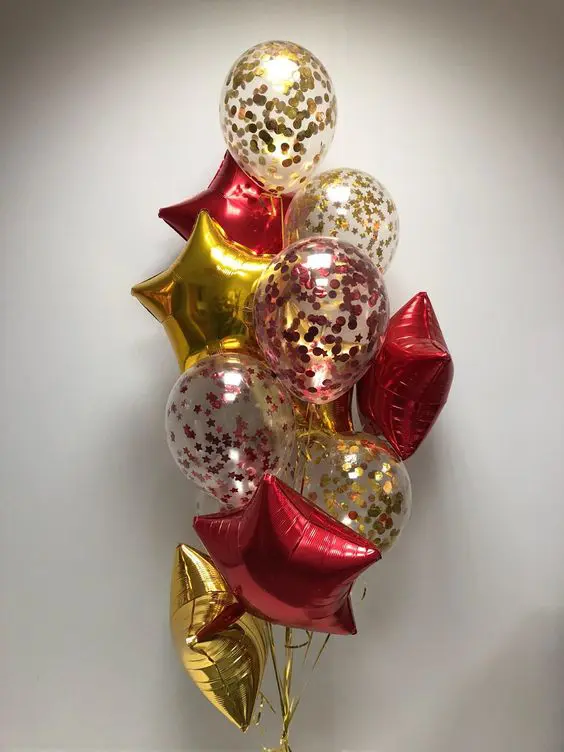 Balloon Lane uses the colors red gold and gold confetti bouquet balloons with big gold and red star balloons for valentines decorations