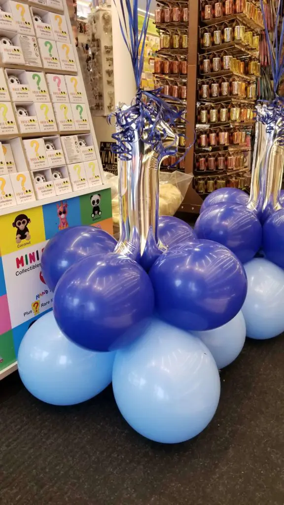 A beautiful balloon decoration featuring Light Blue Chrome Silver, and Sapphire balloons, with Number 1 balloon in Silver
