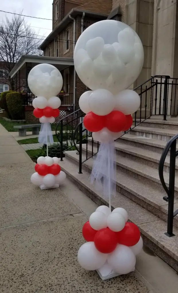A Valentine's Day balloon display in Brooklyn, featuring Pearl White, Diamond Clear, and Red Round Top Column balloons, with mini heart balloons inside the big round balloon.