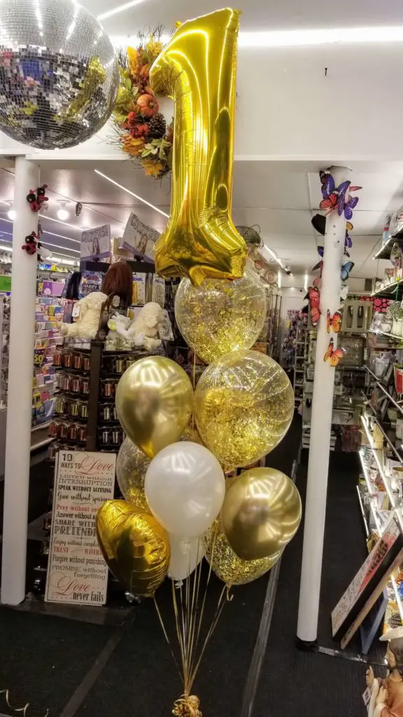 A gold, white, chrome gold, and black balloon bouquet with number balloons 1, perfect for balloon decoration in NJ.
