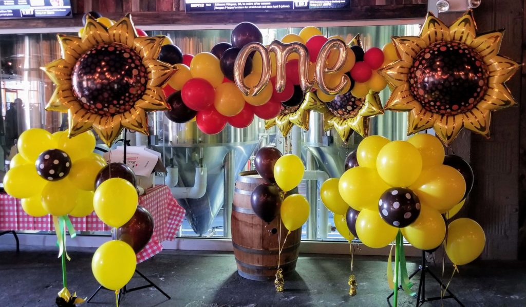 Balloons Lane Balloon delivery Brooklyn in using colors Yellow Chocolate Brown White Mocha Brown and Chrome® Rose Gold balloons With Letter balloons one in Chrome Gold Column for 1st birthday