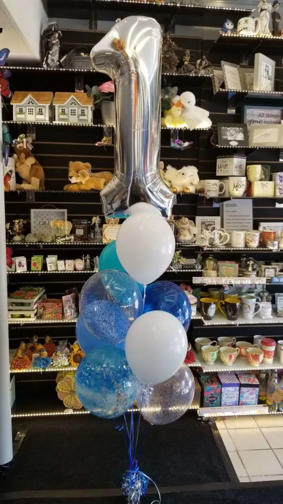 A gorgeous balloon bouquet in Purple, White, Silver, and Winter Green colors, with Number Balloons 1 in Silver is perfect for a special occasion decoration.