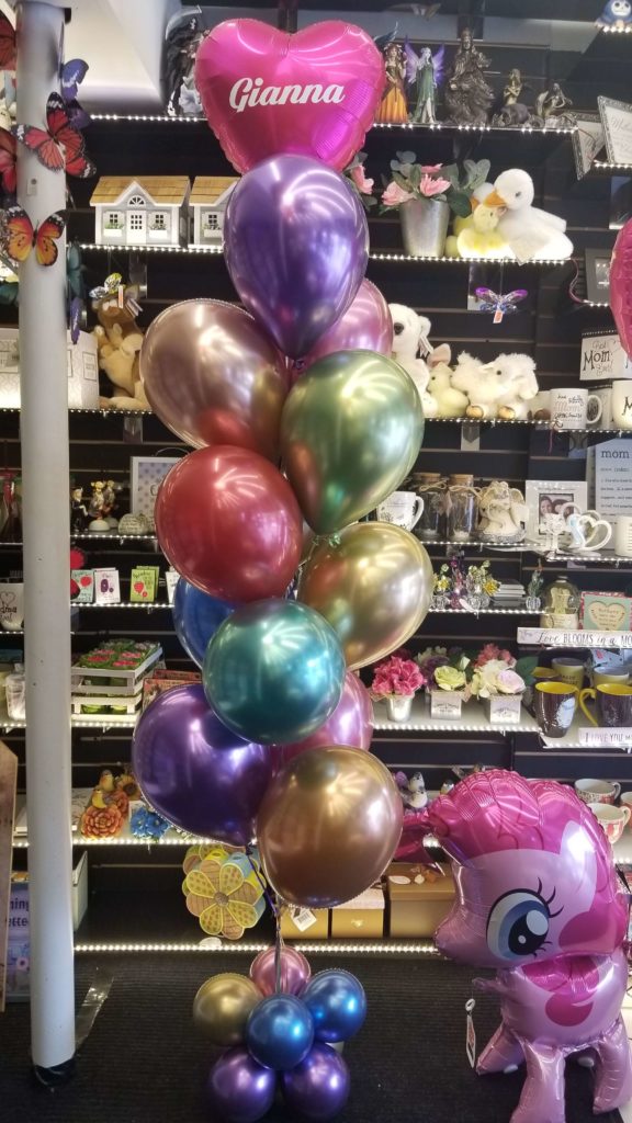 Balloons Lane Balloon delivery New York City in using colors Chrome Blue Chrome Purple Chrome Gold Chrome® Mauve Chrome Green Chrome Red and Magenta balloons With Heart balloons in Magenta Arch one year old birthday