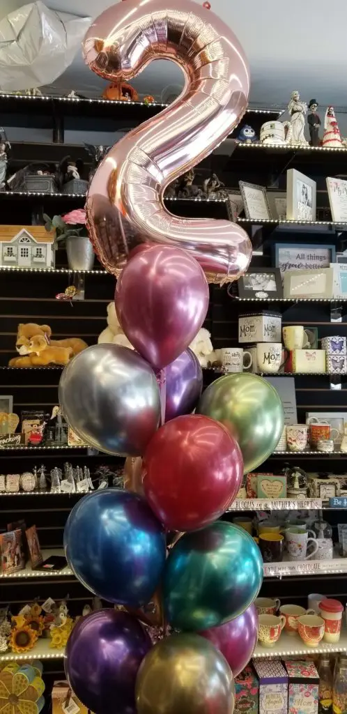 A bouquet of balloons featuring Chrome Mauve, Chrome Purple, Chrome Gold, Chrome Green, Chrome Blue, Chrome Red, Chrome Silver, and Chrome Rose Gold colors, along with number balloons in Rose Gold, arranged in NJ.