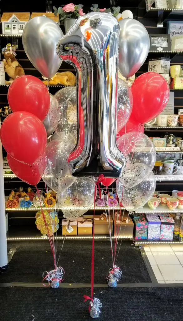 A bouquet of balloons featuring red, silver, and chrome silver colors, along with number balloons in silver, arranged in Brooklyn.
