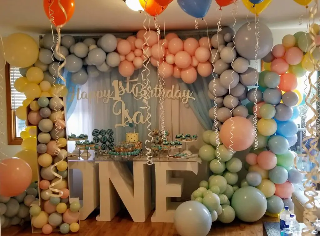 Balloon delivery using colors Mint Green, Pearl White, Pearl Lemon Chiffon, Pearl Azure, Orange, Yellow, and Blue balloon centerpiece for 1st birthday balloon decorations in Brooklyn.
