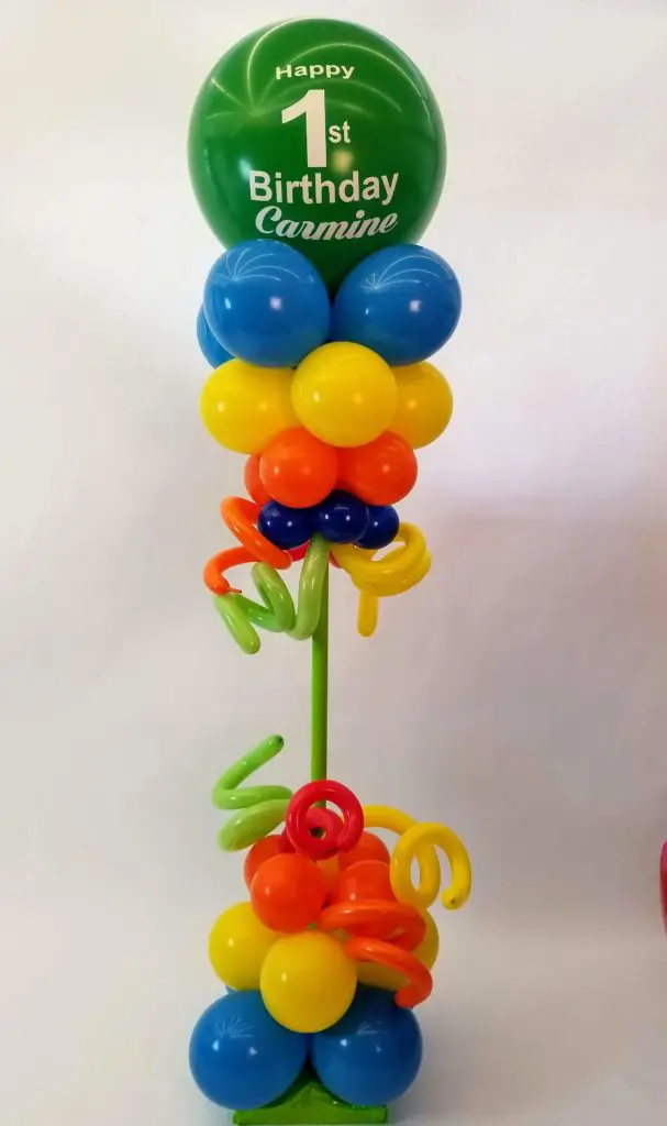 Azure, Yellow, Orange, Green, Blue, and Dark Green balloon decorations with Big round Balloons in Green Arch for 1st birthday celebration in NYC