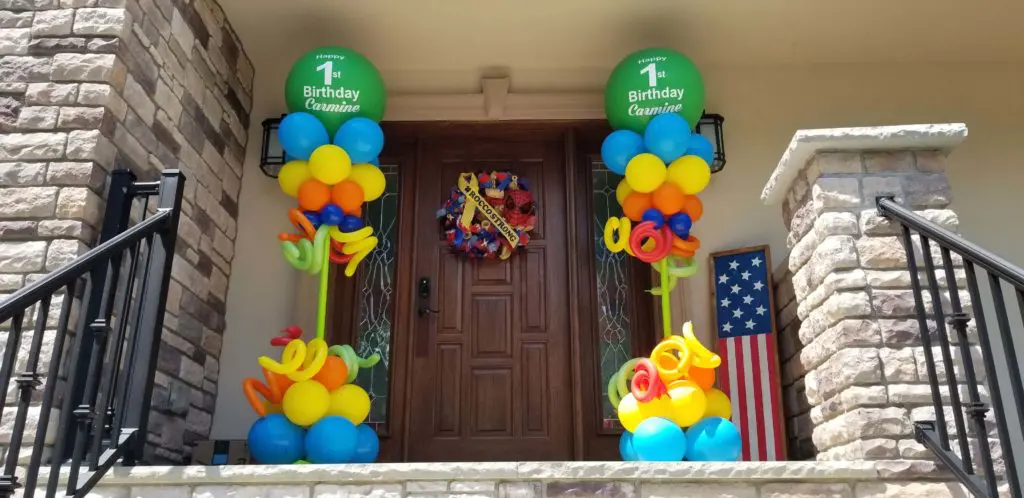 Azure, Yellow, Orange, Green, Blue, and Dark Green balloon decorations with Big round Balloons in Green Arch for 1st birthday celebration in Brooklyn.