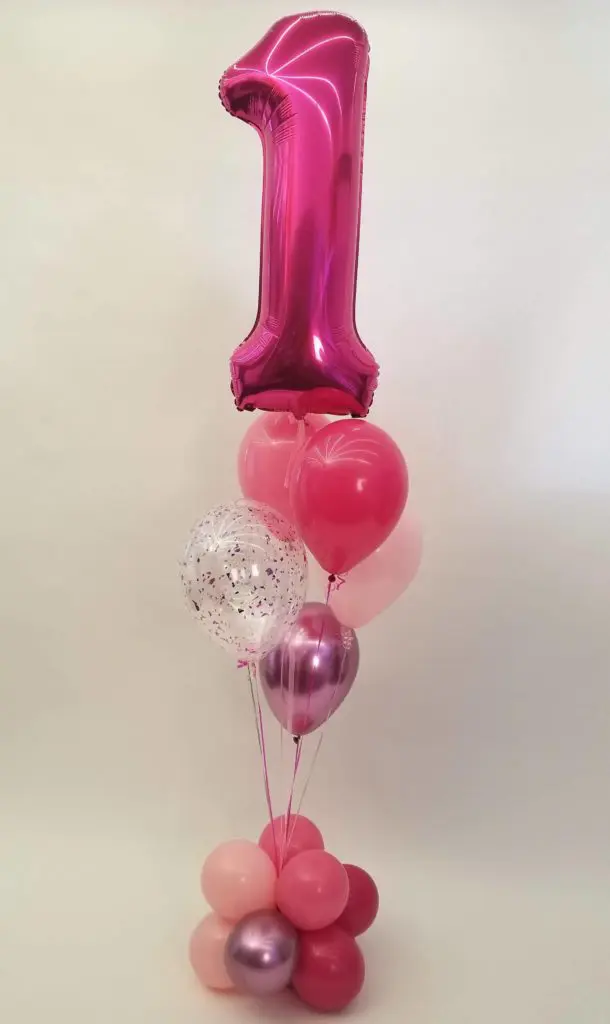 : Ruby Red, Pink, Peach, and Burgundy balloon decorations with Number 1 in Burgundy Balloons Centerpiece for first birthday celebration in New Jersey.