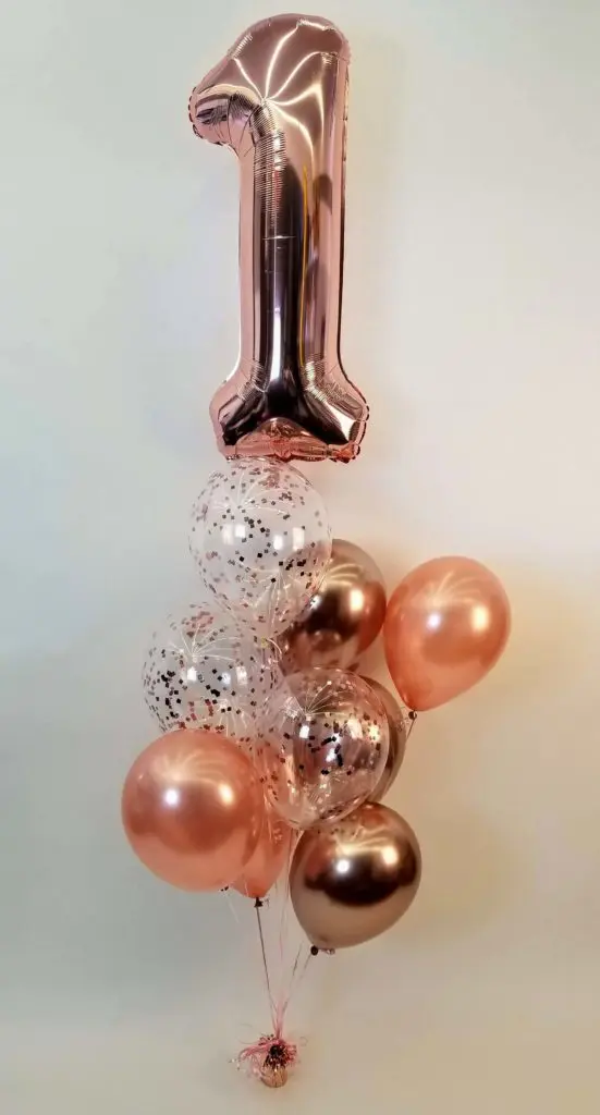 Chrome® Rose Gold, Confetti , and Chrome Gold balloon decorations with number 1 in a rose gold balloon bouquet in Brooklyn.
