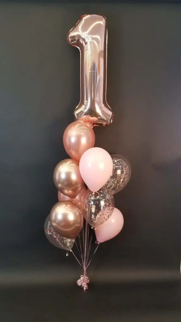 Rose gold and chrome rose gold balloon bouquet with number balloons in chrome rose gold for a first birthday party in NYC.