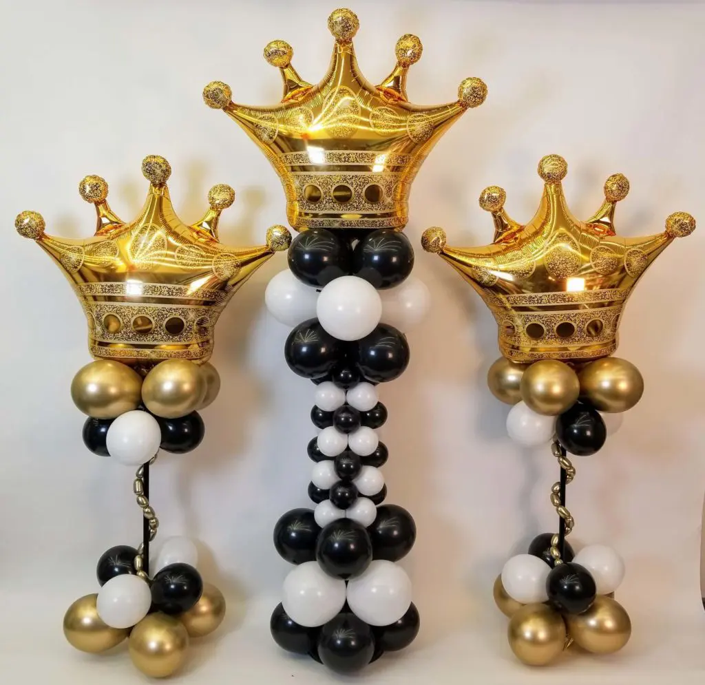 A Jumbo Crown-shaped Foil Balloon in White, Black, Chrome Gold, and Gold colors, as a centerpiece with a black and gold balloon first birthday party.