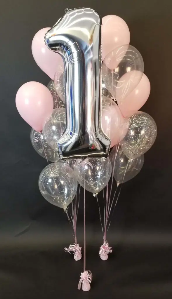 Pink and clear balloon decorations with confetti balloons and a clear balloon with number 1 silver balloon bouquet in NYC.