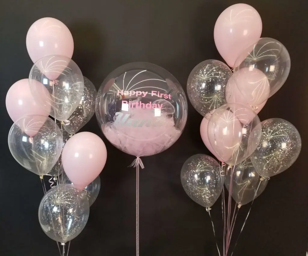 :Pink and clear balloon decorations with confetti and a customized clear balloons with printed name in NJ.