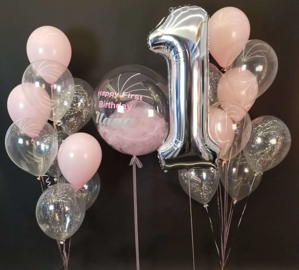 Pink and silver balloon delivery with number balloons in silver and customized clear balloon with printed name in NYC.