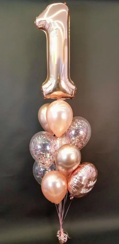 Rose gold and chrome rose gold balloon bouquet with number balloons in chrome rose gold for a first birthday party in NYC.